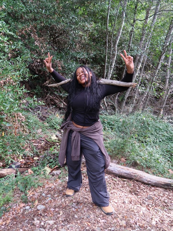 Rachel smiling on a wooded trail